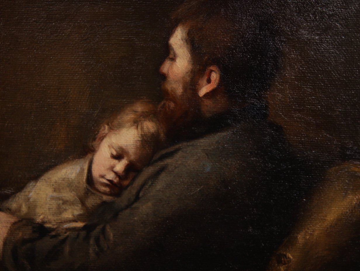 A father holding a sleeping child